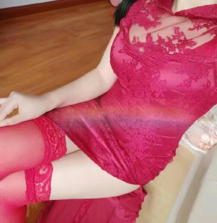 Red lace bra and matching thigh-highs with bands pressing into smooth skin, toes peeking from beneath the hem